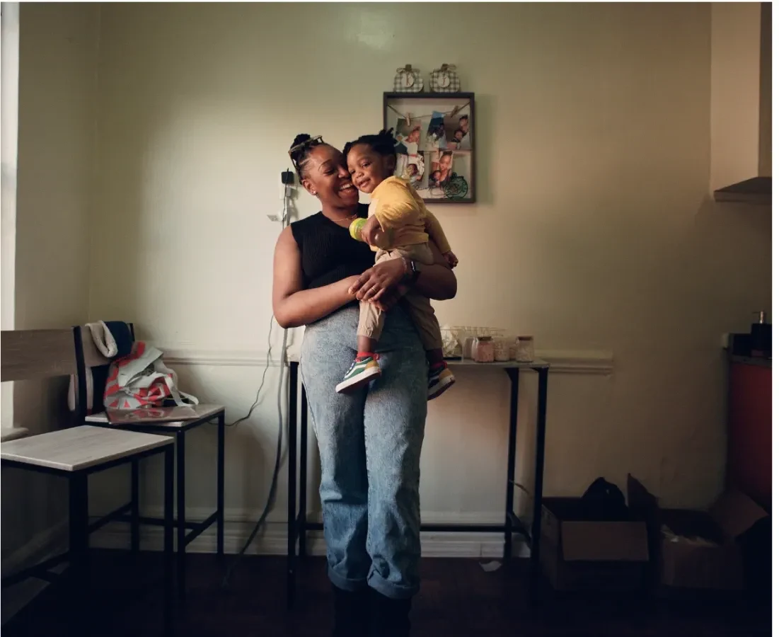A parent holding a child in Grow Therapy’s brand photography