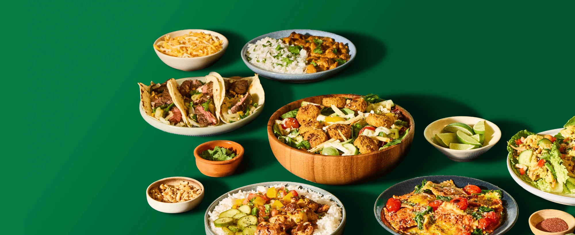 A selection of HelloFresh meals on a green background