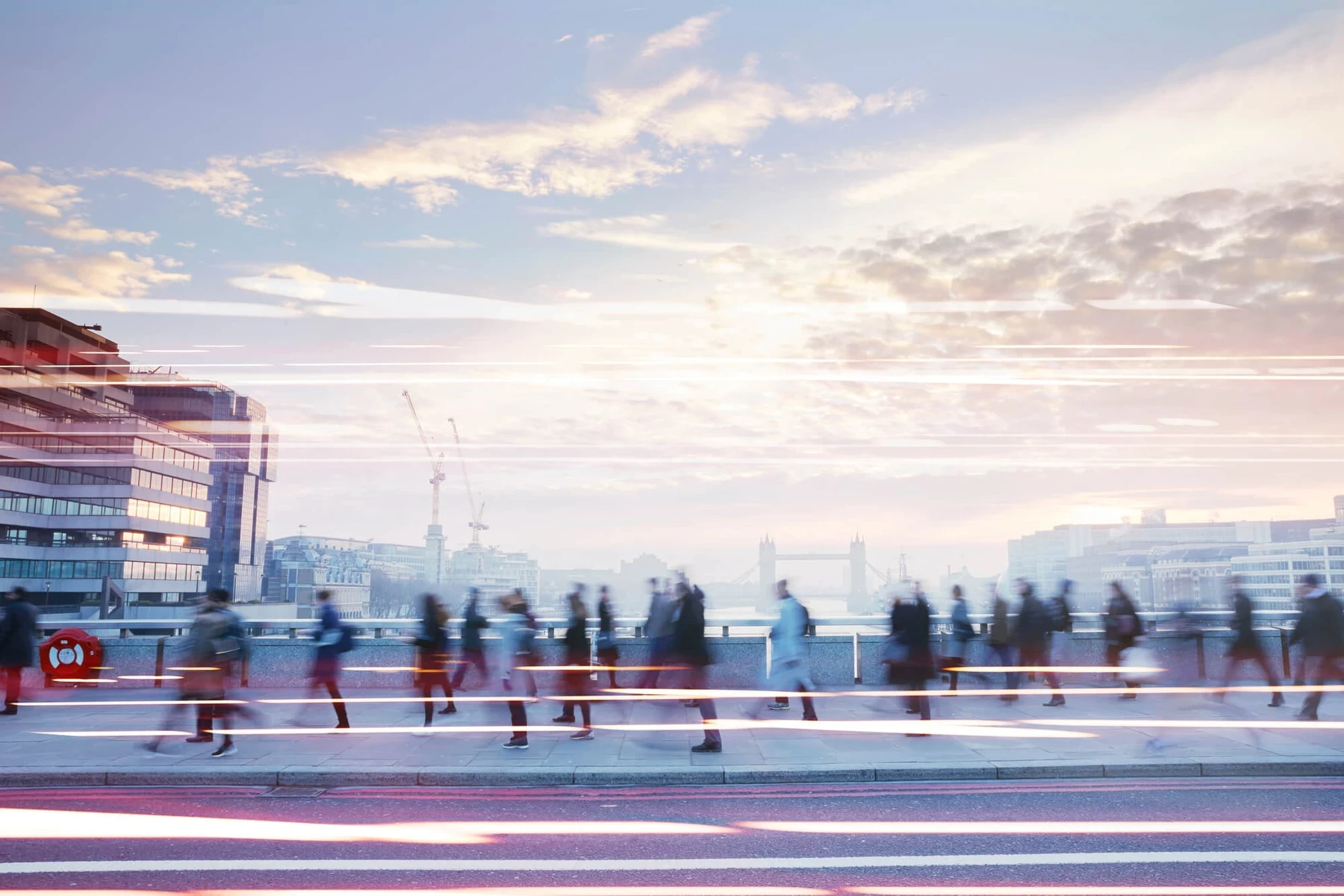 People moving through a city at dusk, from NIQ’s consumer outlook imagery