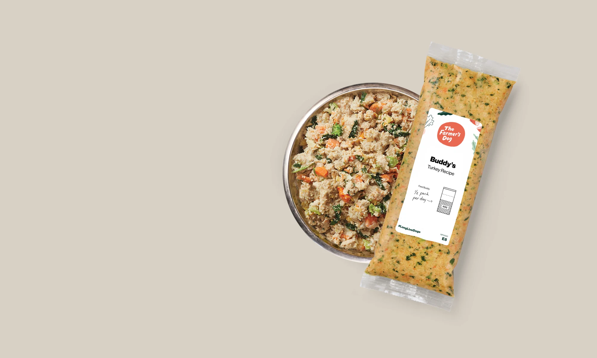 A bowl of fresh dog food beside The Farmer’s Dog meal packaging
