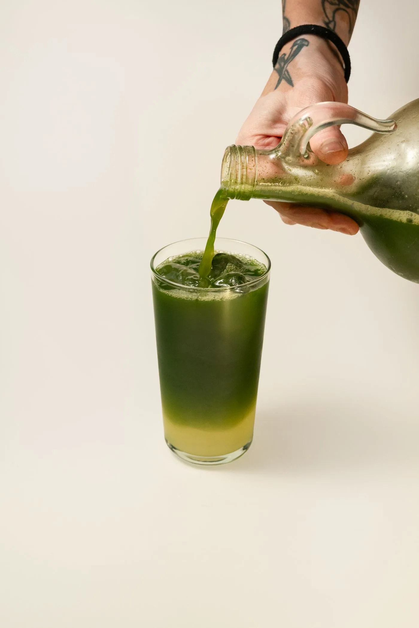 Fresh green juice being poured