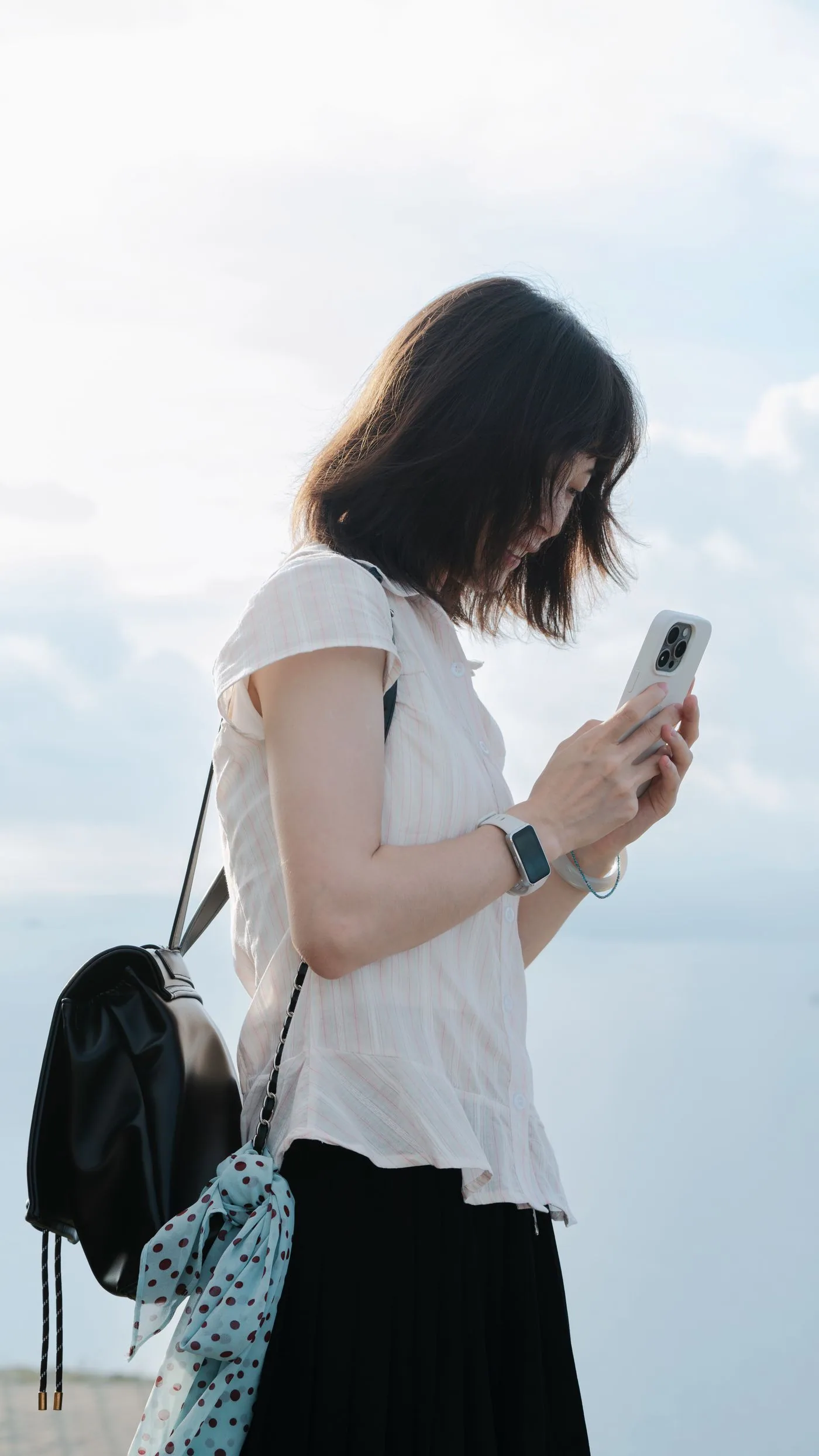 A woman using her phone outdoors