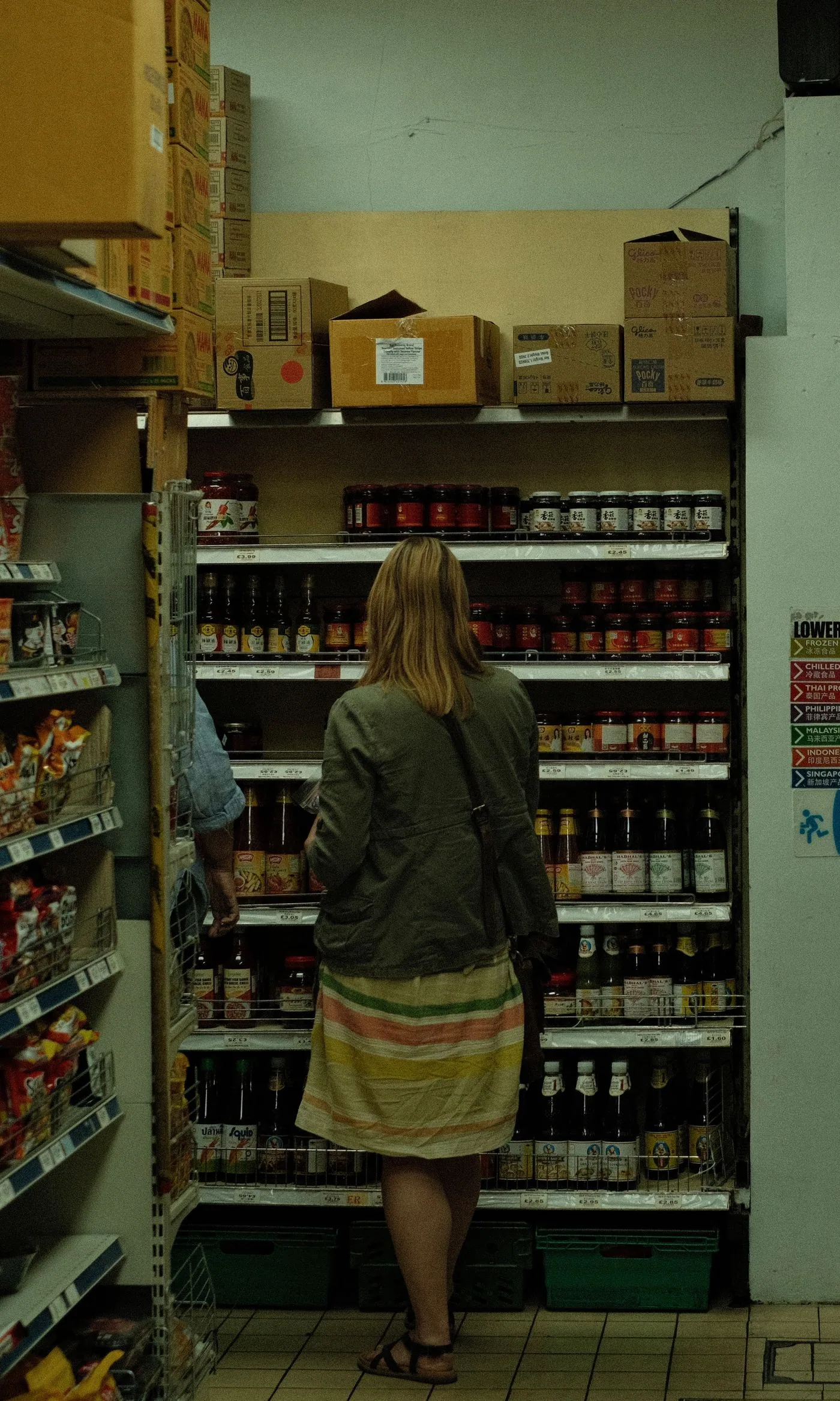 A shopper choosing products in a grocery store